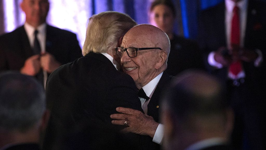 Donald Trump and Rupert Murdoch hugging.