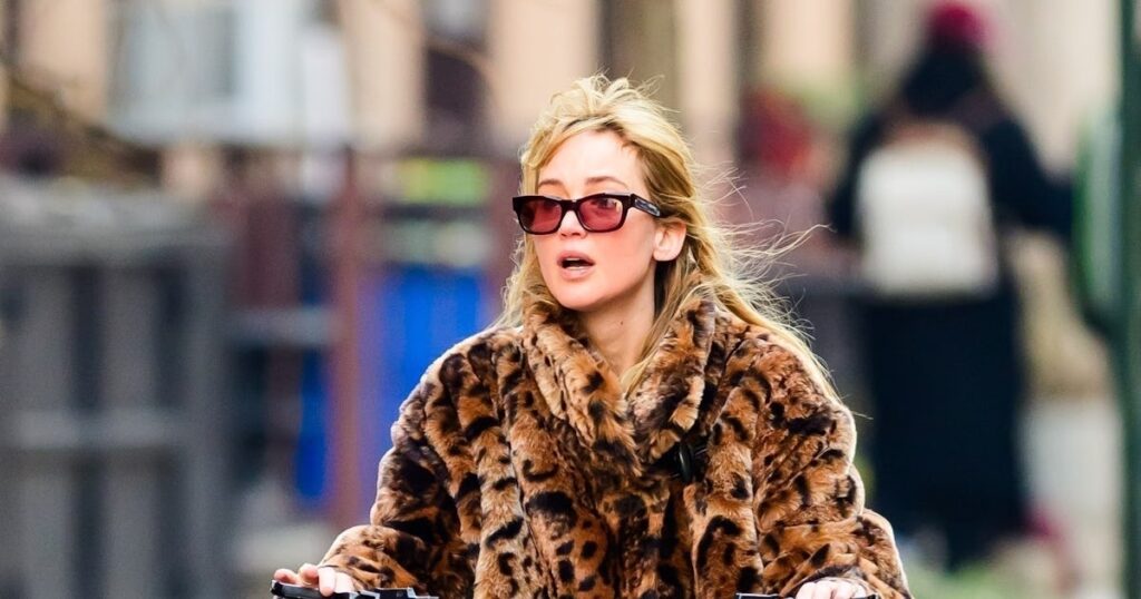 Jennifer Lawrence's Faux Fur Coat & Cult Blue Jeans Make Biking Look Cool