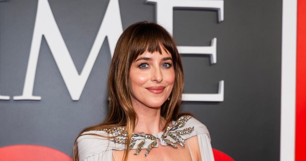 Dakota Johnson Looks Like a Red Carpet Angel in Caped Gown