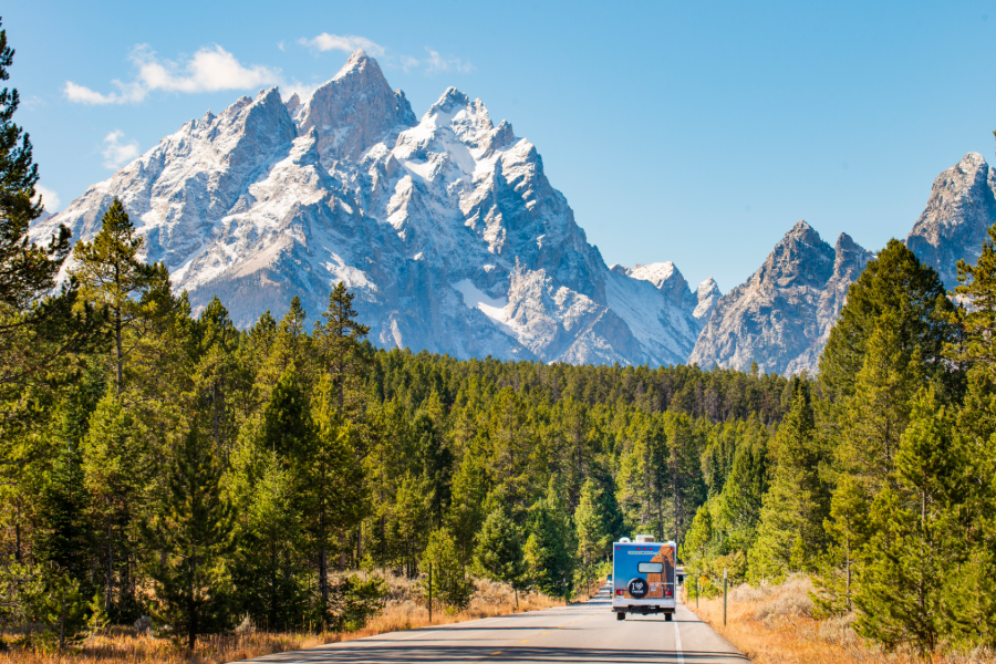 Cruise America Adds Route-Planning Tool for RV Trips RV traveling on Mountain road; Cruise America RoadQuest.ai road trip planning tool