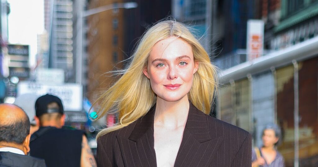 Elle Fanning’s Plunging Pinstripe Suit Is Ready to Close the Deal Elle Fanning's Plunging Pinstripe Suit Is Ready to Close the Deal
