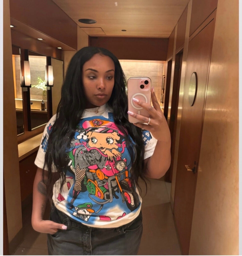 Aida Osman Doesn’t Know Who the Fuck The Rizzler Is Aida Osman taking a selfie wearing a Bettie Boop t-shirt