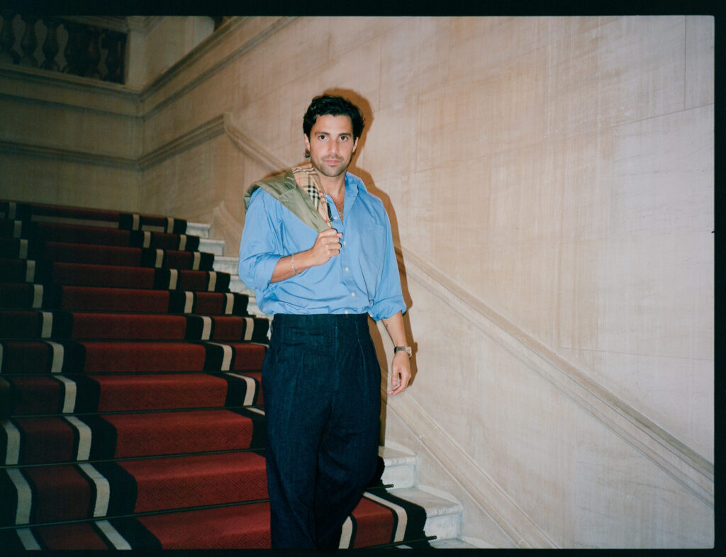Fabien Frankel Finally Knows Who Criston Cole Is Fabian Frankel going down a red staircase holding a Burberry jacket over his right shoulder