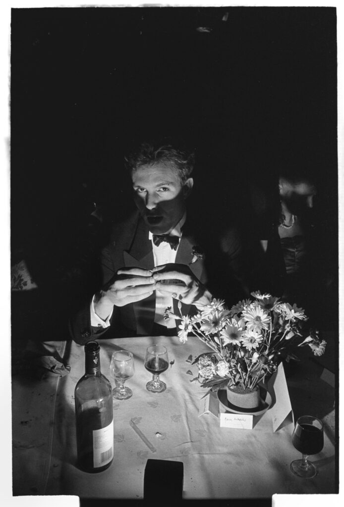 Photographer Dafydd Jones Captures the Young, Rich, and Hedonistic in Cambridge Balls Toby Mansell-Pleydell poses in candlelight with wine at Cambridge May Ball