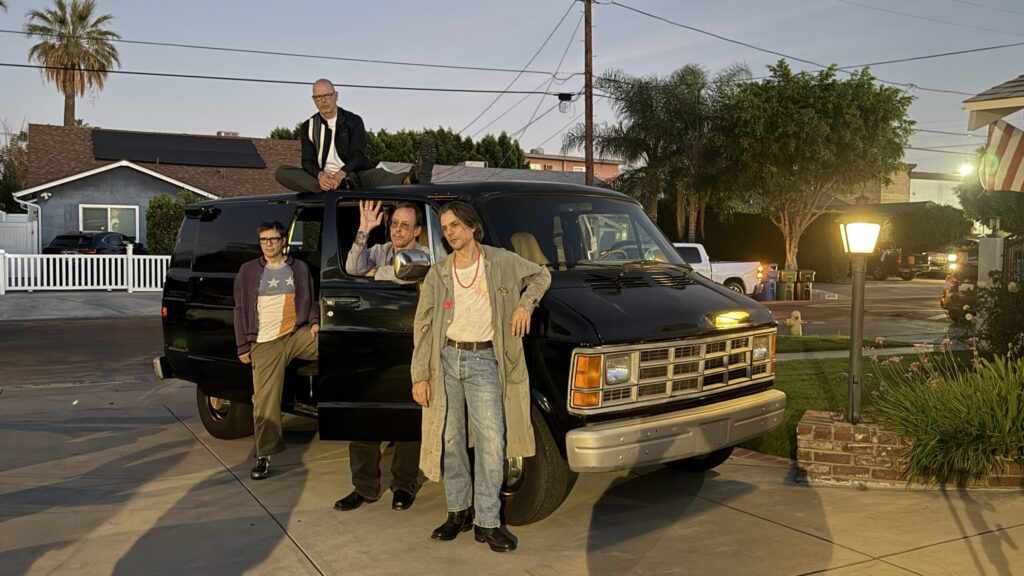 Weezer stands next to a van.