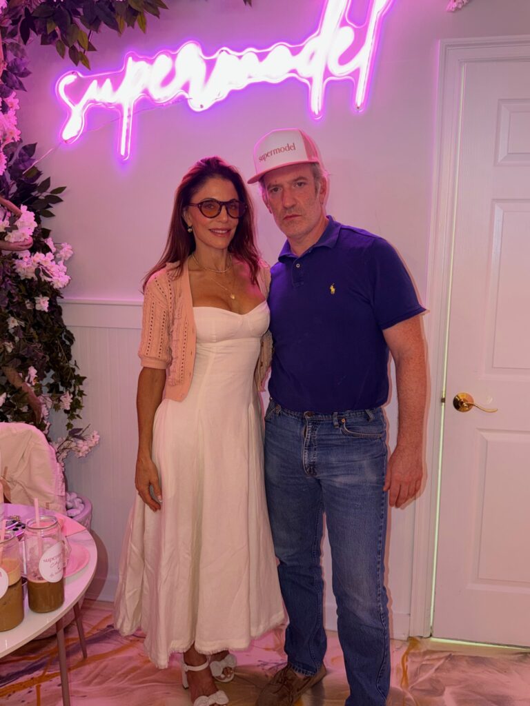 Bethenny Frankel is Going to Keep You Skinny With a $43 Bagel Bethenny Frankel and Mel Ottenberg pose for a photo together under a glowing "Supermodel" sign.