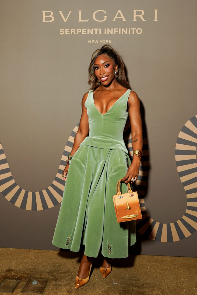 Jackie Aina Walks Us Through Her Glam at the Bulgari Serpenti Infinito Party Jackie Aina poses in a green dress on the bulgari red carpet